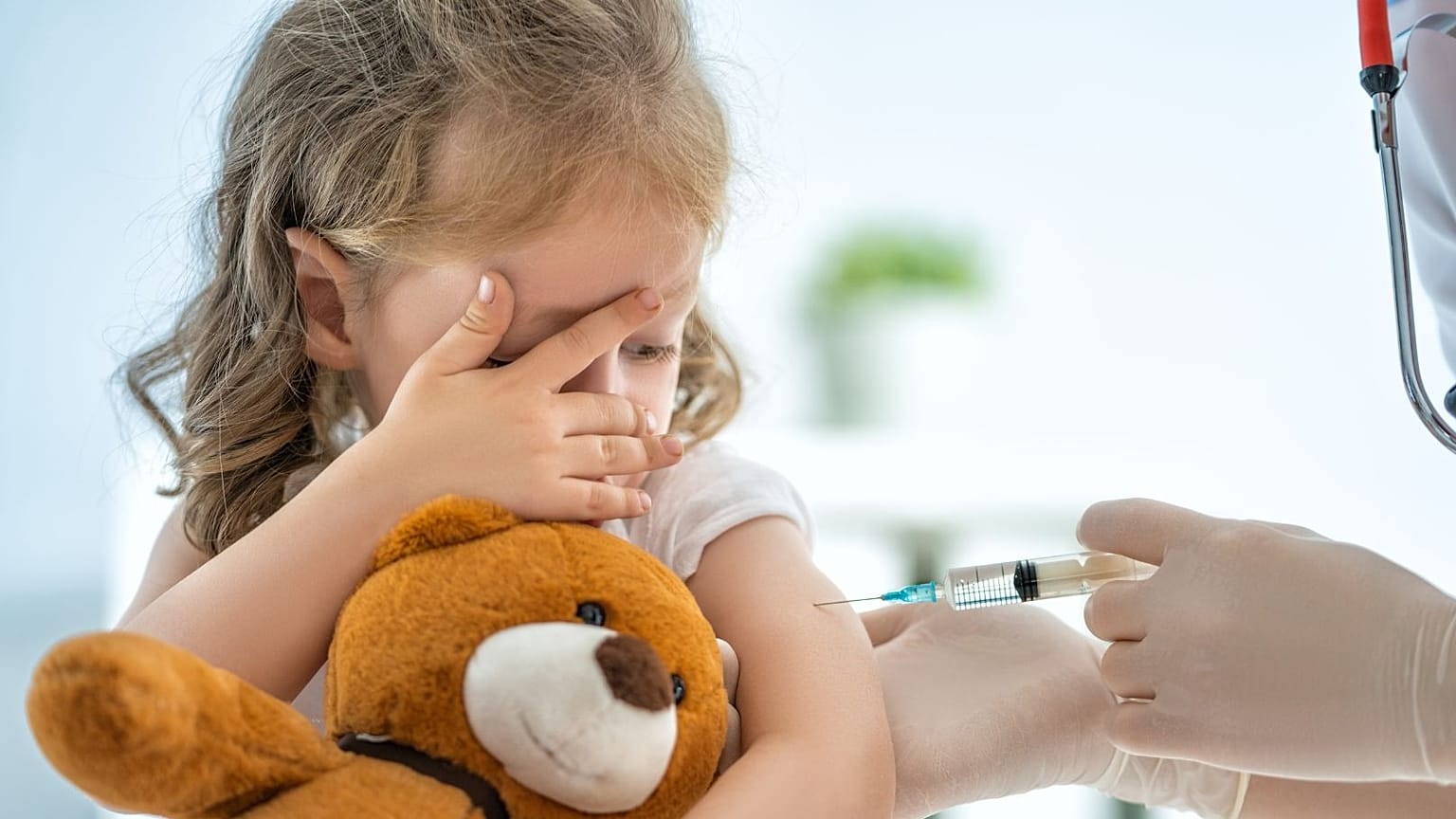A little girl receives a vaccine.