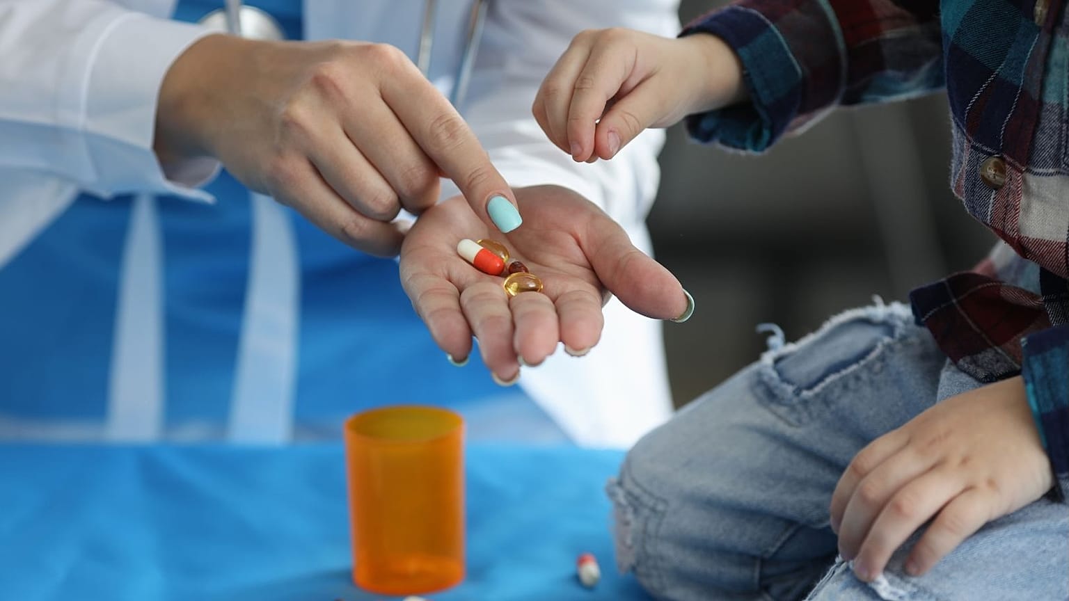 A small child receives medication.