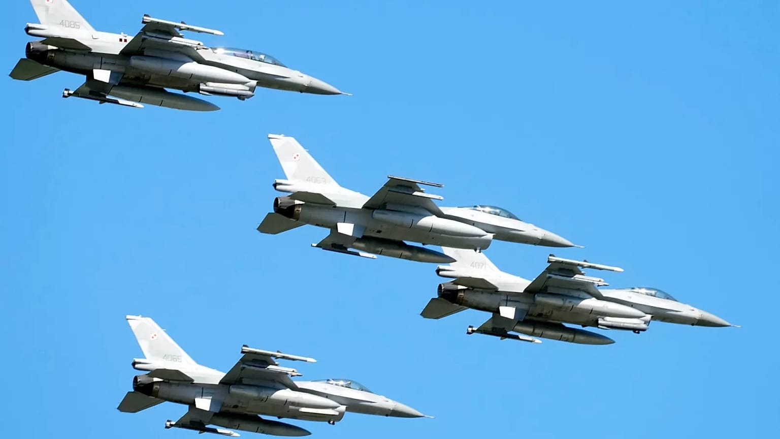 F-16 fighter jets fly in the sky over Poland's capital as they take part in a military parade to celebrate Polish Army Day, 15 August, 2023
