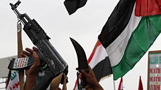 FILE: Houthi supporters shout slogans during an anti-US and anti-Israel weekly rally as they raise a Palestinian flag in Sanaa, 4 July 2025