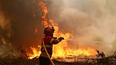 A firefighter works to extinguish a fire on the outskirts of Sever do Vouga, 18 September, 2024