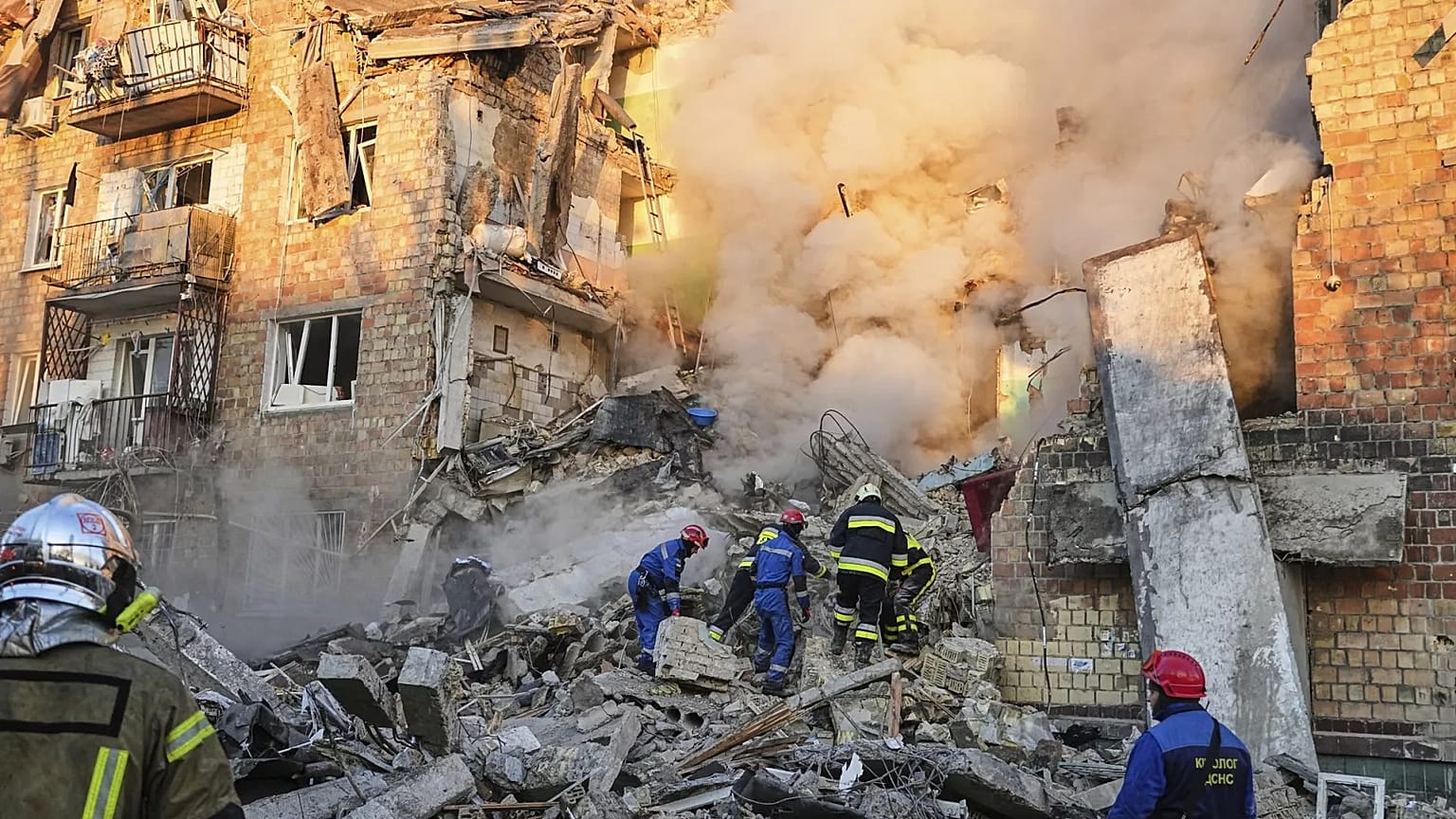 İtfaiyeciler Kiev'de bir Rus saldırısının ardından yanan bir binanın bulunduğu alanda çalışıyor, 28 Ağustos, 2025