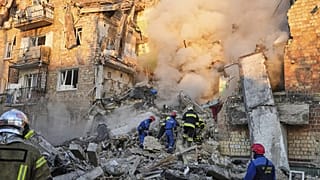 Firefighters work on the site of a burning building after a Russian attack in Kyiv, 28 August, 2025