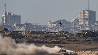 An Israeli armored vehicle moves in an area in the Gaza Strip, as seen from southern Israel, Friday, Aug. 29, 2025. (AP Photo/Maya Levin)