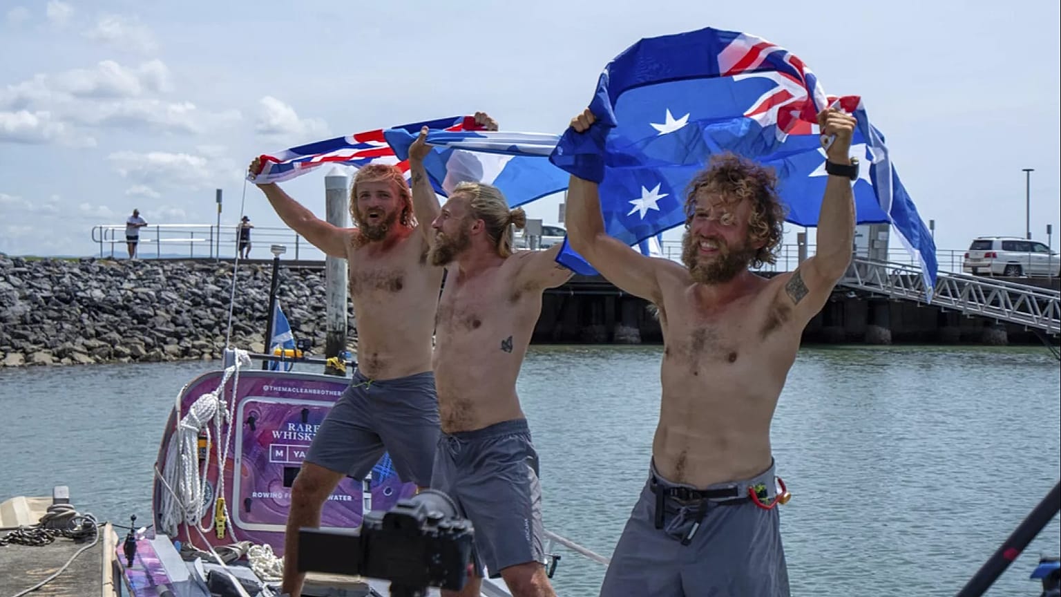 Scottish brothers, Ewan, Jamie and Lachlan, Maclean react after completing their record breaking row from Peru across the Pacific Ocean to Cairns, Australia, Saturday, Aug. 30