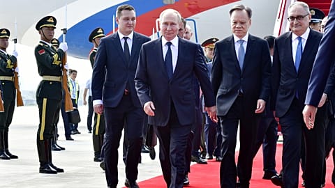 In this photo released by Xinhua News Agency, Russian President Vladimir Putin, center, arrives for the Shanghai Cooperation Organization (SCO) summit in Tianjin, China Sunday