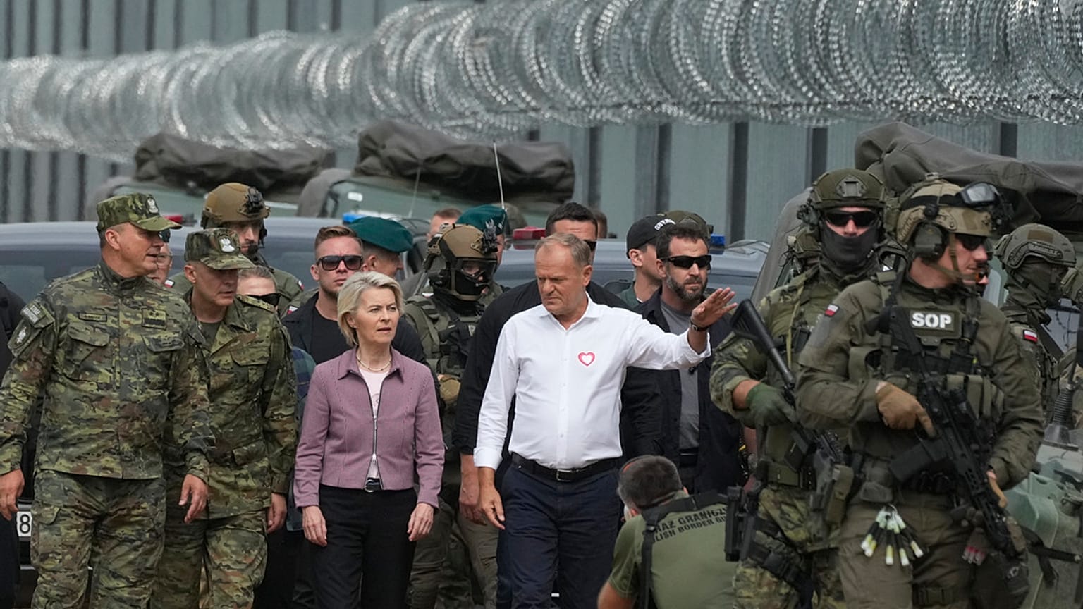 Tusk et von der Leyen s'adressent au personnel des gardes-frontières lors de leur visite à la frontière polono-biélorusse, à Krynki, en Pologne, le dimanche 31 août 2025.
