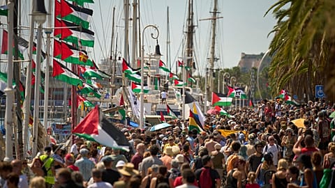 People crowd the dock ahead of the launch of a civilian flotilla bound for Gaza, in Barcelona, Spain, Sunday, Aug. 31, 2025. 