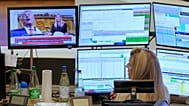 A trader watches a tv news screen showing President Trump on the trading floor of the Frankfurt Stock Exchange in Frankfurt, Germany, Wednesday, April 9, 2025