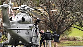 Police board a helicopter at a command area at Feathertop Winery in Porepunkah in Victoria, Australia, on 27 August, 2025.