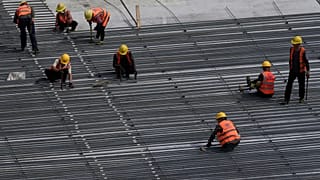 Workers build the China World Trade Centre and the Xiong'an railway station connected to Beijing Daxing International Airport / 30 August 2025