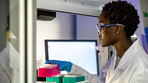 A scientists works in a lab.