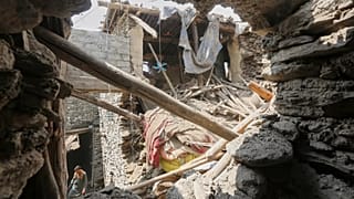 A local resident walks through a partially collapsed house in an area devastated by Sunday's powerful earthquake in Dara Noor, 2 September, 2025