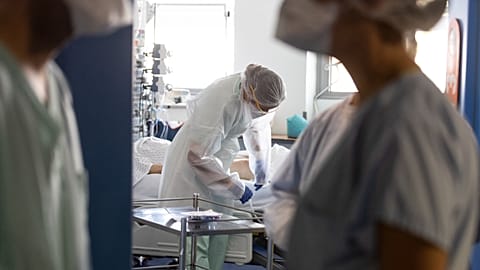 A medical worker tends a patient at the Nouvel Hospital Civil of Strasbourg in France, on Sept.15, 2020. 