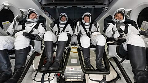 In this photo provided by NASA, a cosmonaut and astronauts are seen in a SpaceX spacecraft shortly after having landed in the Pacific Ocean near California on Aug. 9, 2025.