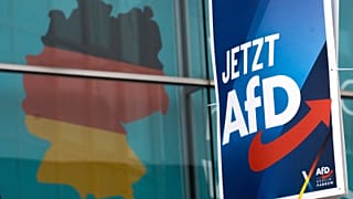 An election poster of the German far right Alternative for Germany party (AfD) in front of a giant election poster showing a map of Germany, Jan. 29, 2025