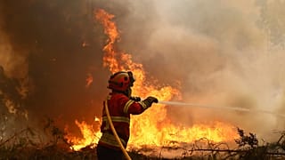 A firefighter works to extinguish a fire on the outskirts of Sever do Vouga, Portugal, which has been surrounded by forest fires for several days, Wednesday 19 September 2024.
