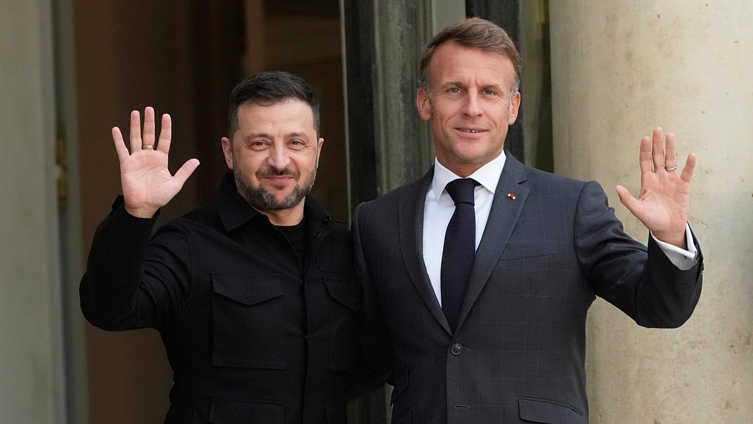 French President Emmanuel Macron and Ukraine's President Volodymyr Zelenskyy wave to journalists prior to a meeting, at the Elysee Palace, in Paris, France, Sept. 3, 2025.