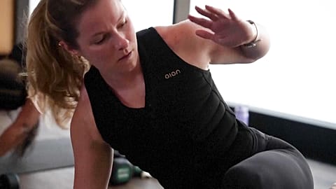 A woman wearing a weighted vest during MB360 class at Life Time, New York, USA.