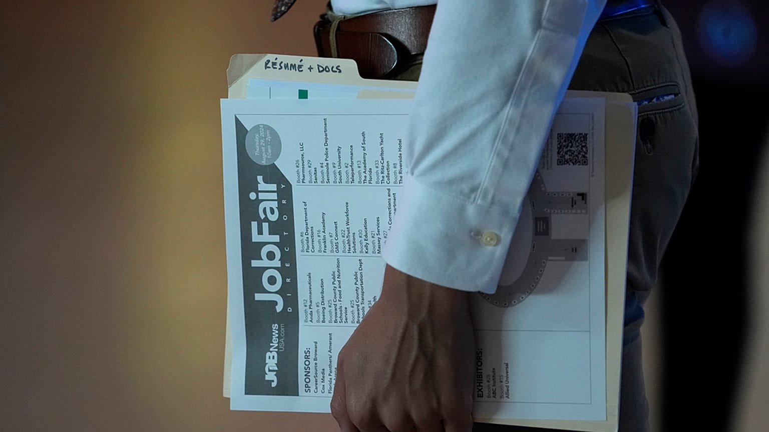 FILE - A person waits in a line for a prospective employer at a job fair, Thursday, 29 August 2024, in Sunrise, US.