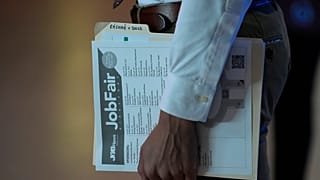 FILE - A person waits in a line for a prospective employer at a job fair, Thursday, 29 August 2024, in Sunrise, US.