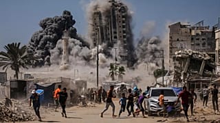 Palestinians run for cover during an Israeli airstrike on a high-rise building in Gaza City, 5 September, 2025