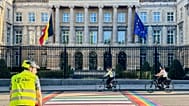 People cycle past the Belgian Parliament in Brussels, Belgium, Tuesday, Sept. 2, 2025. 