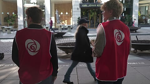Campaign volunteers from the Labour Party stand on the sidewalk looking for people to engage with in Oslo, Sunday, Sept. 7, 2025.