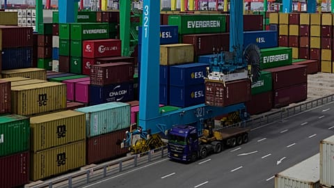 A crane loads a shipping container into a truck at an automated container port in Tianjin, China.