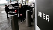 FILE - In this March 15, 2017, file photo, a sign marks a pick up point for the Uber car service at LaGuardia Airport in New York.