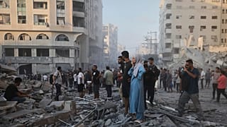 Palestinians inspect the damage after an Israeli army strike on a building in Gaza City, 7 September, 2025