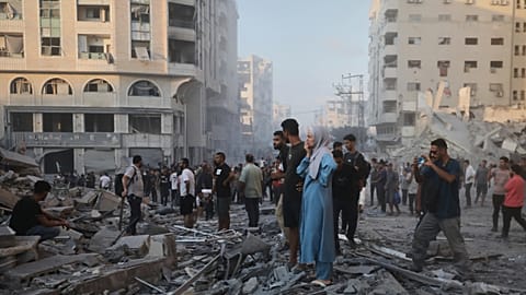 Palestinians inspect the damage after an Israeli army strike on a building in Gaza City, 7 September, 2025