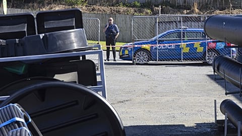 A police officer stands near a hardware store in Piopio in the Waikato district of New Zealand, Monday, Sept. 8, 2025.