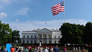 Visitors walk outside of the White House on 13 July, 2025. 