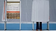 A person stands in a polling booth during Norway’s Parliamentary elections in Slattumhallen, 8 September, 2025