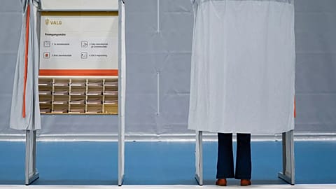 A person stands in a polling booth during Norway’s Parliamentary elections in Slattumhallen, 8 September, 2025