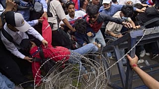 Un manifestante cade durante gli scontri con la polizia antisommossa fuori dal parlamento a Kathmandu, Nepal, lunedì 8 settembre 2025