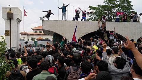 Protesters shout slogans as they gather outside the Parliament building in Kathmandu, Nepal, Monday, Sept. 8, 2025. 