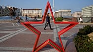 People walk in Independent Square during sunset in Minsk, 5 July, 2023