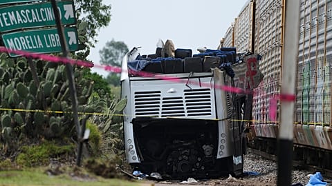 The wreckage of a double-decker bus lies next to the goods train that rammed it in Atlacomulco, Mexico, Monday, Sept. 8, 2025. 