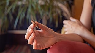 A woman holds a joint.