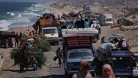 Displaced Palestinians fleeing northern Gaza carry their belongings along the coastal road toward southern Gaza, 9 September, 2025