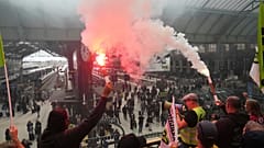 Railway workers hold smoke bombs at the Paris Gare de Lyon train station during 'Block Everything' protests in French capital on Wednesday 10 September, 2025.