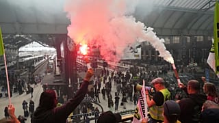 Railway workers hold smoke bombs at the Paris Gare de Lyon train station during 'Block Everything' protests in French capital on Wednesday 10 September, 2025.