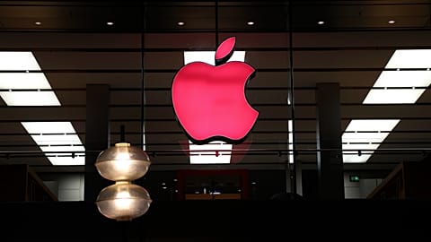 FILE - In this Sunday, Dec. 6, 2020 file photo, the logo of Apple is illuminated at a store in the city center of Munich, Germany. 
