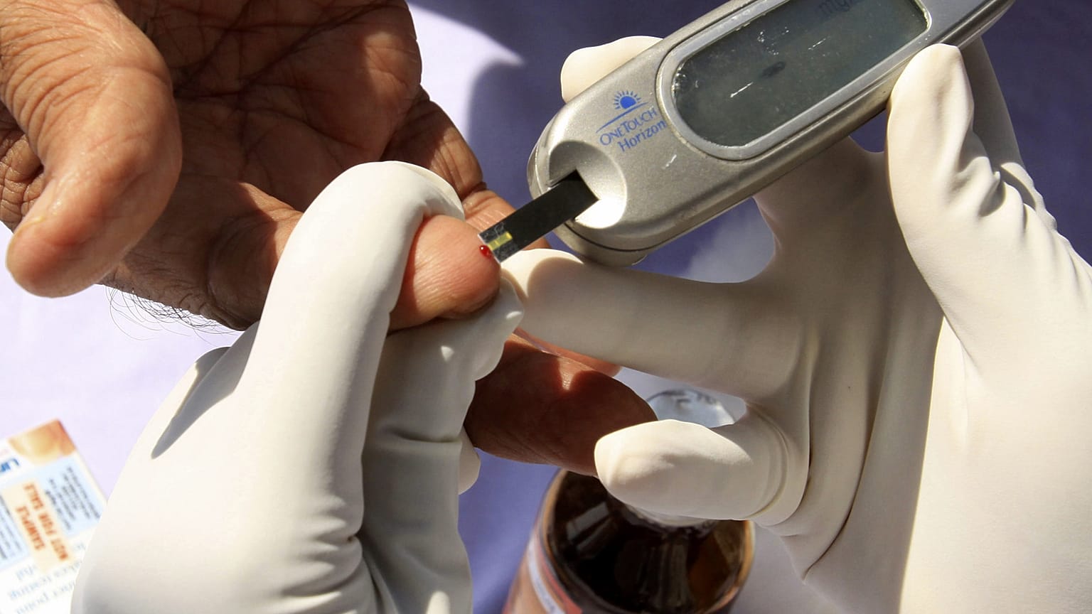 ممرضة تجمع عينة دم من مريض خلال حملة فحص مجاني للسكري في حيدر أباد، الهند
