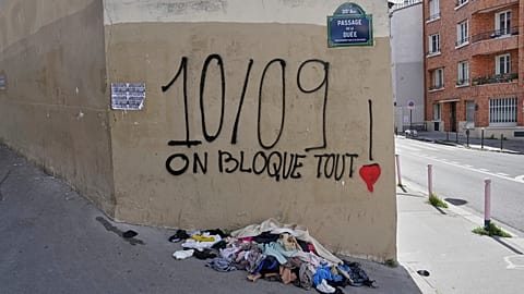 A graffiti reads, "September 10, we shut everything down" in Paris, Tuesday, Sept. 9, 2025, at the eve of a national protest. 