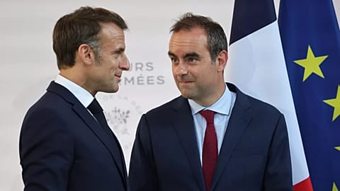 French Defence Minister Sébastien Lecornu and France's President Emmanuel Macron talk at the end of an address by the president to army leaders in Paris, 13 July, 2025