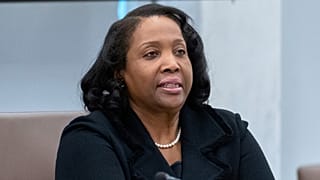 FILE - Federal Reserve Board of Governors member Lisa Cook listens during an open meeting of the Board of Governors at the Federal Reserve. 25 June 2025.