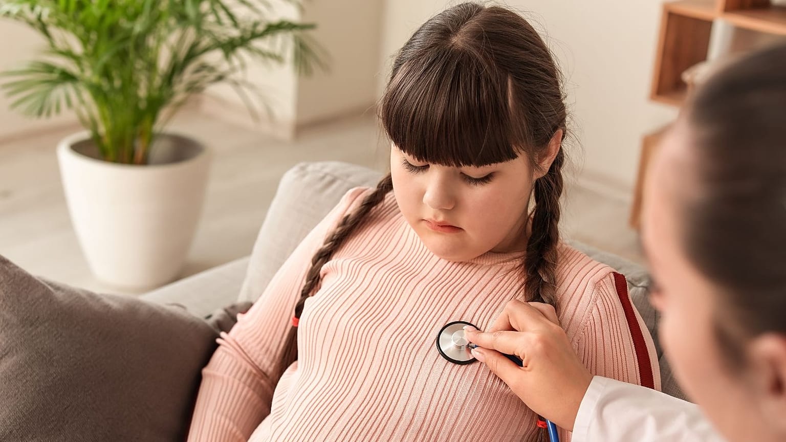 A doctor examines a young girl.